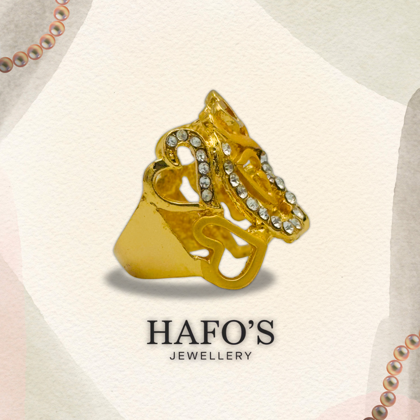 Gold ring with intricate design and gemstones on a light background with 'HAFO'S JEWELLERY' branding.