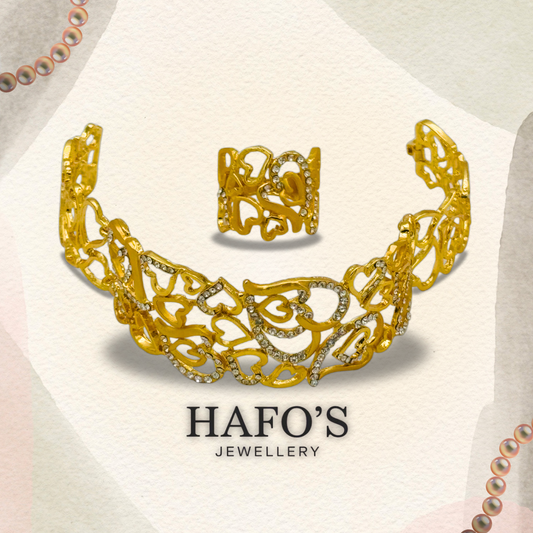 Gold ring with intricate design and gemstones on a light background with 'HAFO'S JEWELLERY' branding.