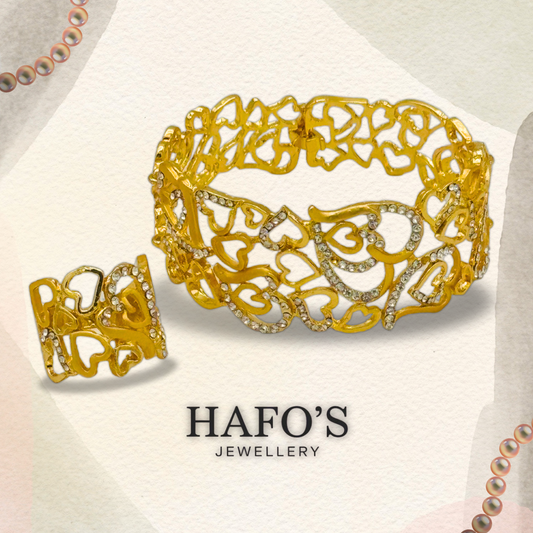 Gold ring with intricate design and gemstones on a light background with 'HAFO'S JEWELLERY' branding.